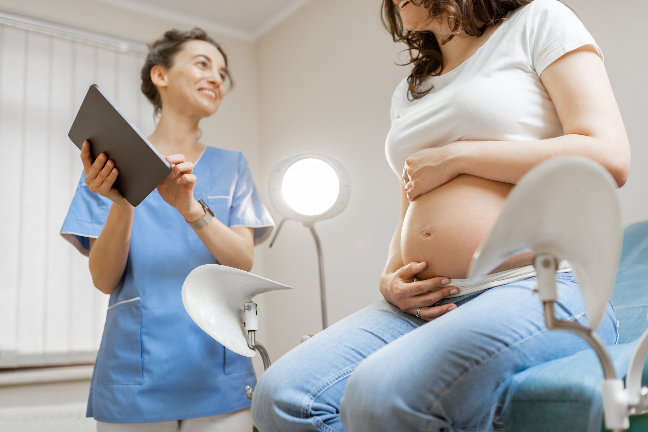Nurse with Pregnant Woman During a Medical Consultation